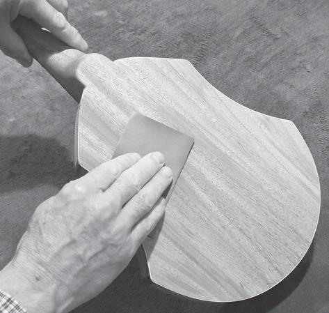 As soon as you have coated the instrument, use paper towels or cloth rags to wipe off all excess finish, right down to the wood (fig 61b). Make sure to wipe the corners too.