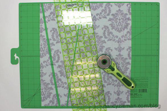 Place the traced fabric on a cutting mat, align an acrylic ruler along the