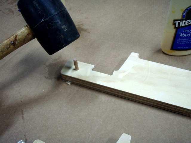 Insert two dowel pins into the first half,