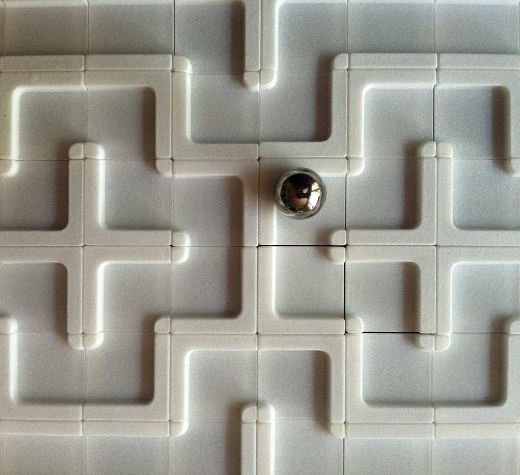 The player can then turn the game s knobs to tilt the board and maneuver a steel ball through the loop. Figure 5: A laser-cut version of Loop 4e (left) and a loop made out of 3D-printed tiles (right).