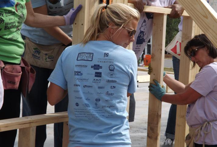 in her official Women Build shirt. PAGE 6 Two fundraisers increased support for Women Build. Our annual buy and paint a beam benefit was expanded to a Beam-A-Thon sponsored by Freshfields Village.