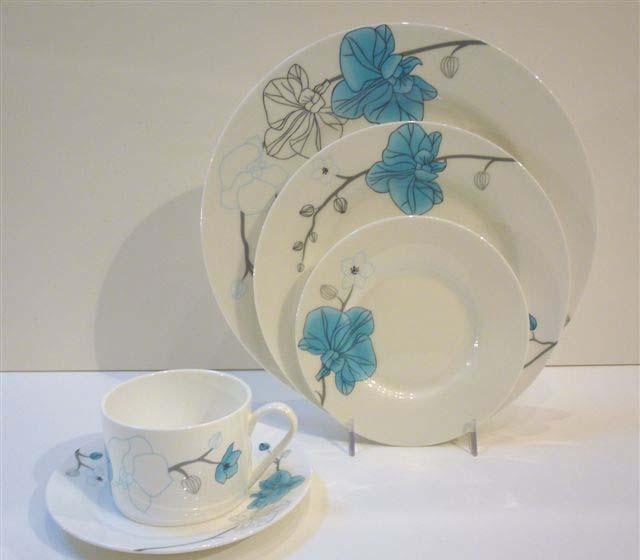 The detailed line work of the orchids adorn sleek bone china to create an elegant