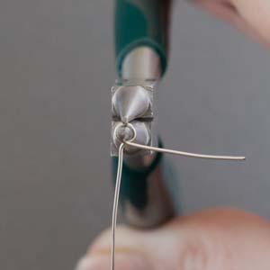 Step 15 Using round nose pliers, begin to make a loop with the wire leaving a 1-inch tail.