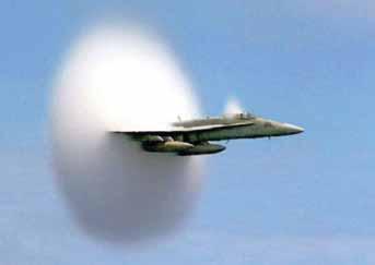 When a plane goes faster than the speed of sound, a sonic boom shock wave occurs.