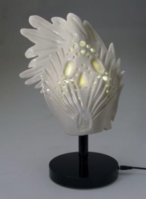 Translucent Porcelain removable top with light holes and black aluminum stand, Lit Sculpture in white.