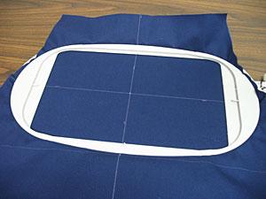 Spray a piece of medium weight cutaway stabilizer with temporary adhesive and smooth the fabric on top.