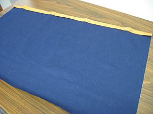 To prepare the pocket for the front of the apron, cut a piece of fabric to 28 inches wide by 16 inches high.