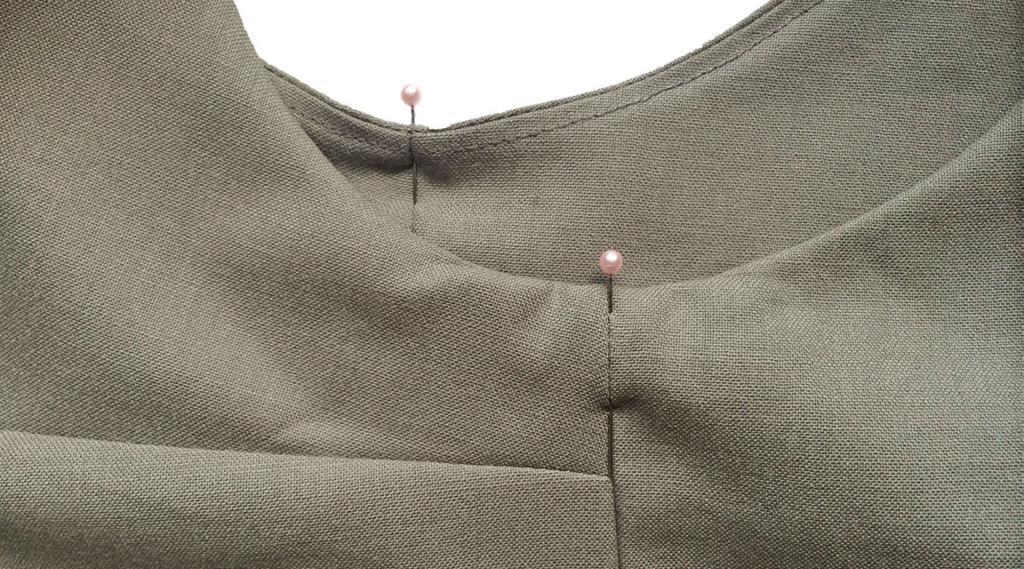 Press the neckline and armholes flat and once everything is the correct shape, pin the side seams of the facing and body pieces together. 5.