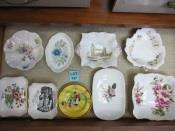 00 147 A collection of 9 ceramic pin trays including