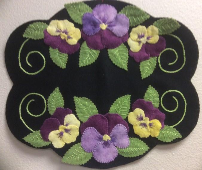 17: 1-4 pm Pansy Wool Candle Mat If you've been curious about wool projects this class is for you. You will learn how to appliqué with wool and hand embroider using 4 basic stitches.