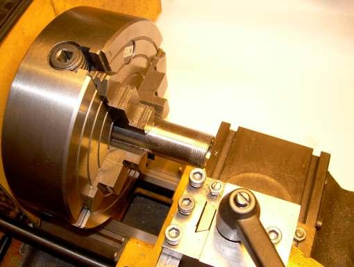 The bush was pressed onto the mandrel, and the mandrel was mounted between centres in the lathe (right picture).