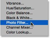Choosing a Photo Filter adjustment layer. This opens the same New Layer dialog box we saw earlier. Select the Use Previous Layer to Create Clipping Mask option by clicking inside its checkbox.