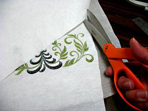 When the designs have finished, trim away the excess stabilizer on the backside of the embroidery.