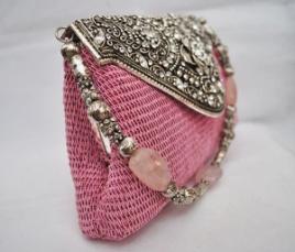 while the sling is worked in carved silver and pink crystal