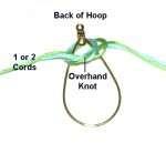 Step 1: Tie a loose Overhand knot in the center of the cords.