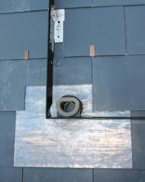 . Replace the slates, retaining them using the tingles by bending them over the bottom edge of each tile. Note: Do not replace the slates where the flashing kit is to be fitted.