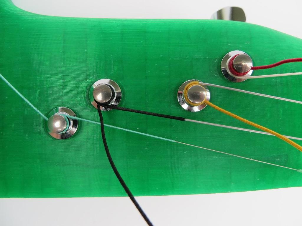 Allow enough slack in the string to get 2-3 complete turns around the tuner. 2. Pass the string over the tuner to make the first wrap, send the string under the tag end for the first wrap. 3.