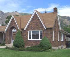 Springville Period Revival Essential Elements Asymmetrical façade Steeply pitched gable roof Steeply pitched cross gables Simulated thatched roofs Prominent chimney Windows with divided lights For