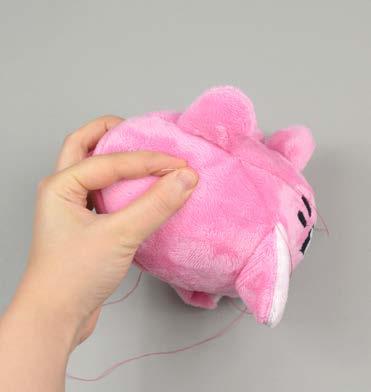 Insert the needle from the inside of the opening and out of the plush near one edge of the