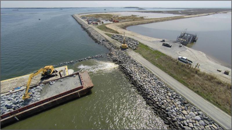 Rock being placed for the dike construction photo credit David Gray (U.S.