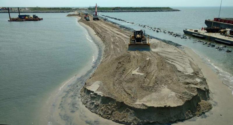 After a perimeter dike is completed, dredged material can then be placed inside the cell.