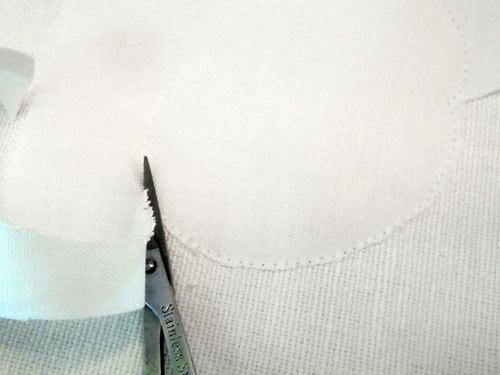 11. Step three is to trim the excess fabric close to the stitched outline.