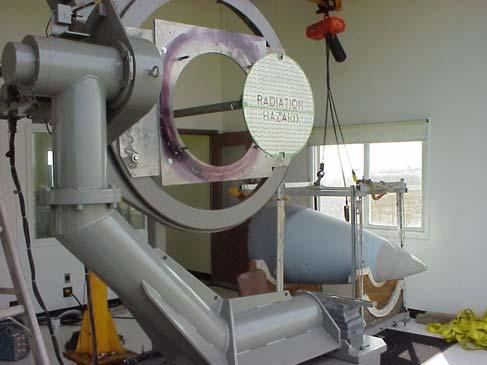 Figure 4 includes a picture of the installed scanner, viewed in the direction of the receive radome positioner (in the building in the background).