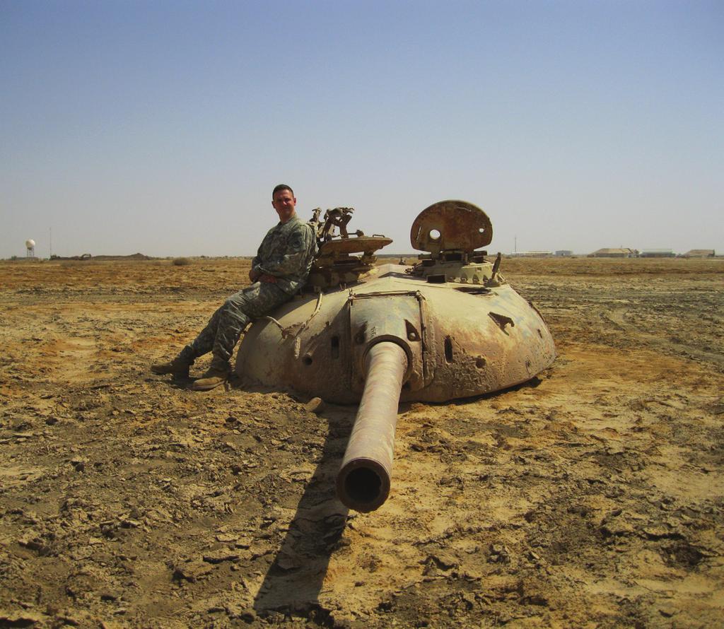 Brewer in a helicopter. Brewer next to the top half of an Iraqi tank at the Contingency Operating Base (COB), Tallil, Iraq (2011).