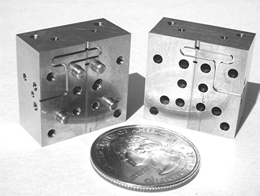 a tuning stub that was too high; a circular waveguide offset from the intersection of the four blocks; and a difference in the height of the four quadrants of the tuning stub.