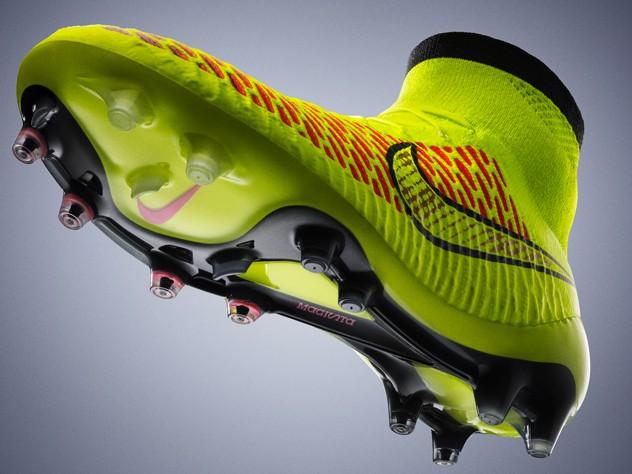 & Q. (a) Nike unveiled the new Magista Boot Volt in 04 as shown above. Describe how consumer demand influences the design of football boots, with regards to the sport.