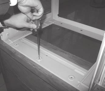 Secure the case to the window sill by using 3 Type D screws. NOTE: Do not shut the window so tightly that movement of the accordion panels is restricted.