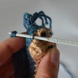 Loop strands onto a stitch