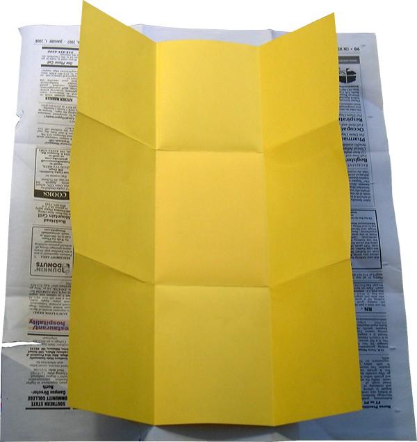 The secret: The yellow piece of paper is actually 2 pieces glued back to back. Each paper is folded in exactly the same way.
