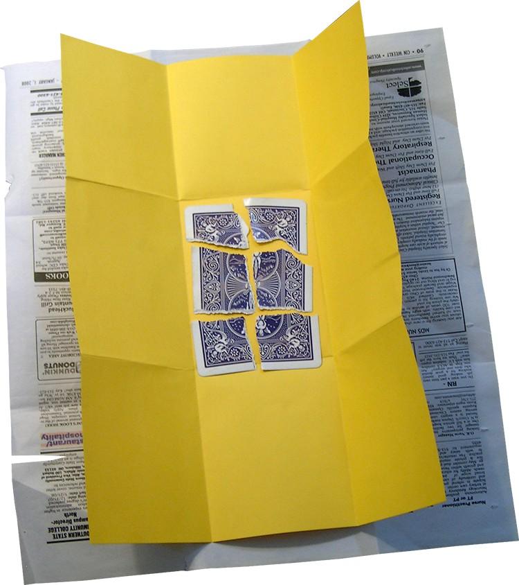 When opening the newspaper and yellow paper, be careful not to show the back of the yellow paper. Nobody should know it's double sided.