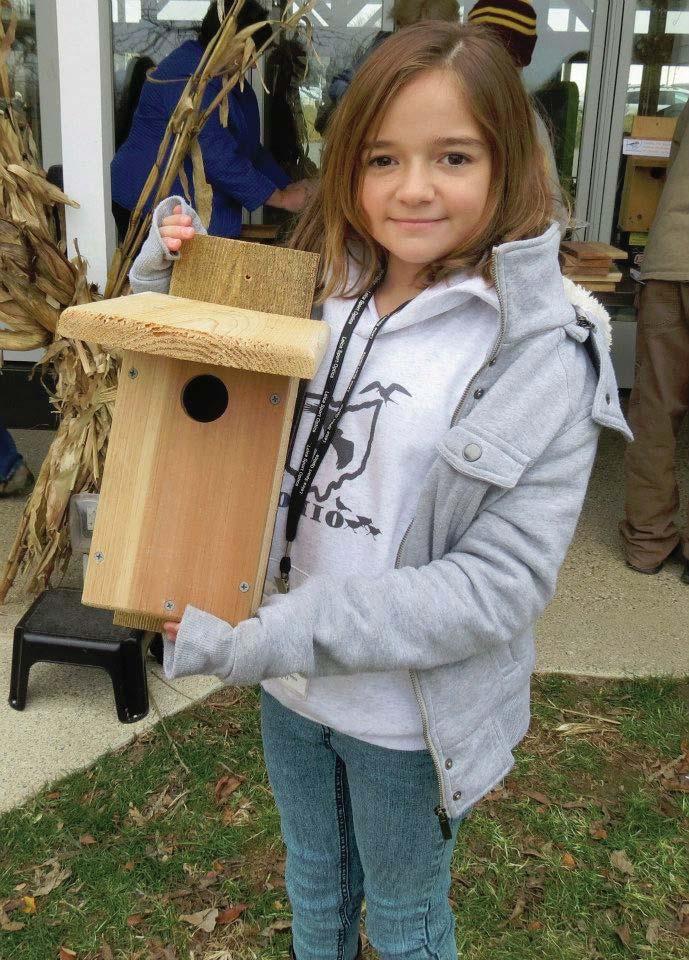 news page This girl is putting a bird house near her feeder. Even News-2-You has a bird feeder! How can you help?