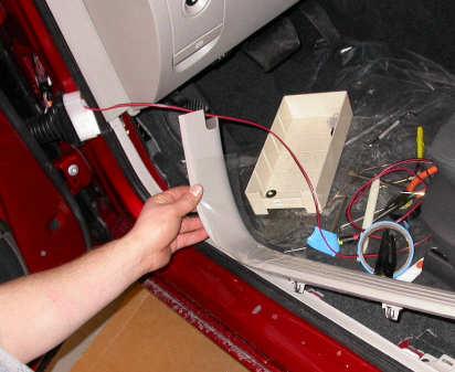 2) Using the slotted screw driver, push and pry the rubber boot connector off of the vehicle frame side.