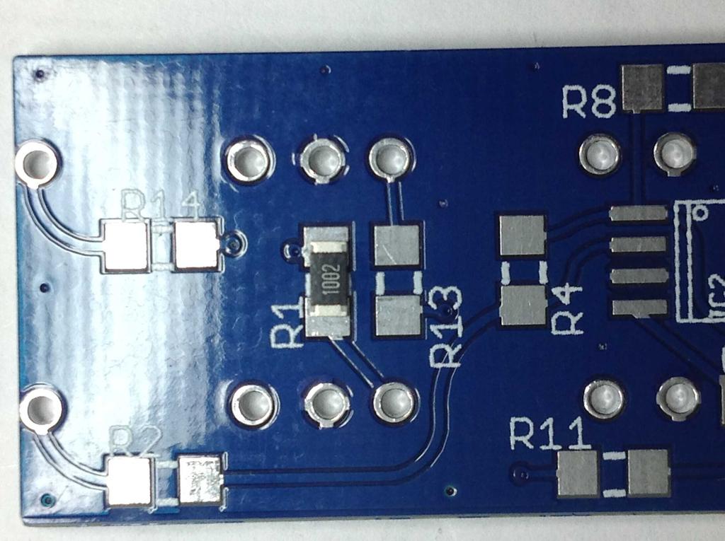 Place the tip of your soldering iron on one of the PCB pads for R1, & immediately apply a small amount of solder to the pad. Remove the iron tip.