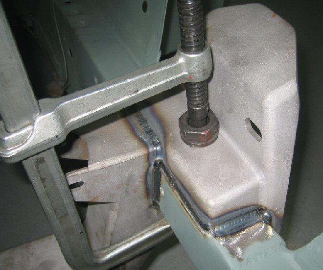 Use a C-clamp from the inside and pull the bracket down snug to the top of the frame rail.