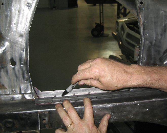 Remove excess material around shock tower opening until it is flat to the fender panel;