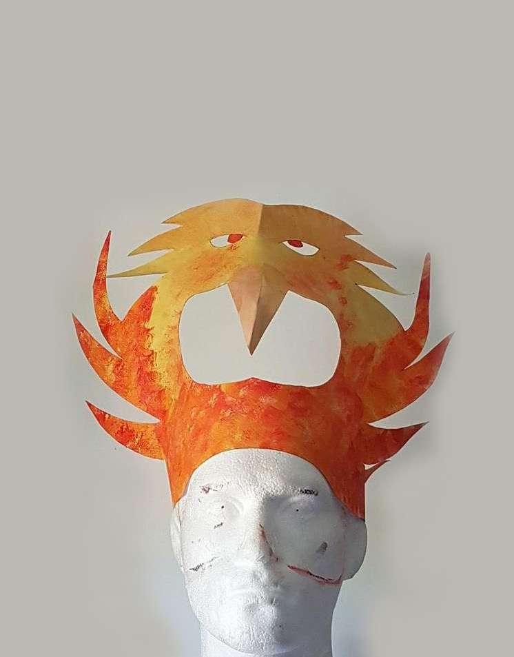 Tribe four: Phoenix Headdress Example decoration Method: Cut out template (on following page). Use a craft knife to cut out the eyes Leave the pupils to give detail.