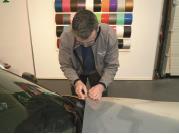 The adhesive layer has then completely bonded with the car body. 1. Cut a piece of vinyl from the roll, which is big enough to completely cover the car part to be wrapped. 2.
