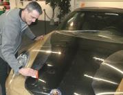 Gently remove the film again at those locations and spray a bit of the tack solution on both the car body and the adhesive layer.