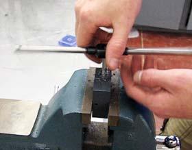 Place the pump body in the bench vise for tapping.