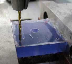 Using the milling machine, drill the four screw holes