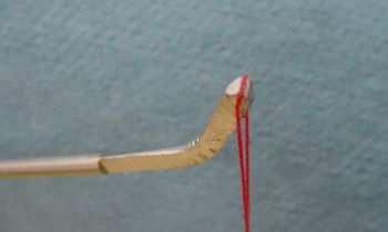 4.4. The second rod acts as a handle and is of a longer length, about 12 inches. The last ½ inch on one end is bent at approximately 45 degrees.