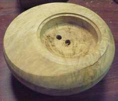 To shape the curved top surface of the bowl you have two options - either turn the rounded top while the bowl is attached by the original screw chuck, shaping from the headstock outwards and