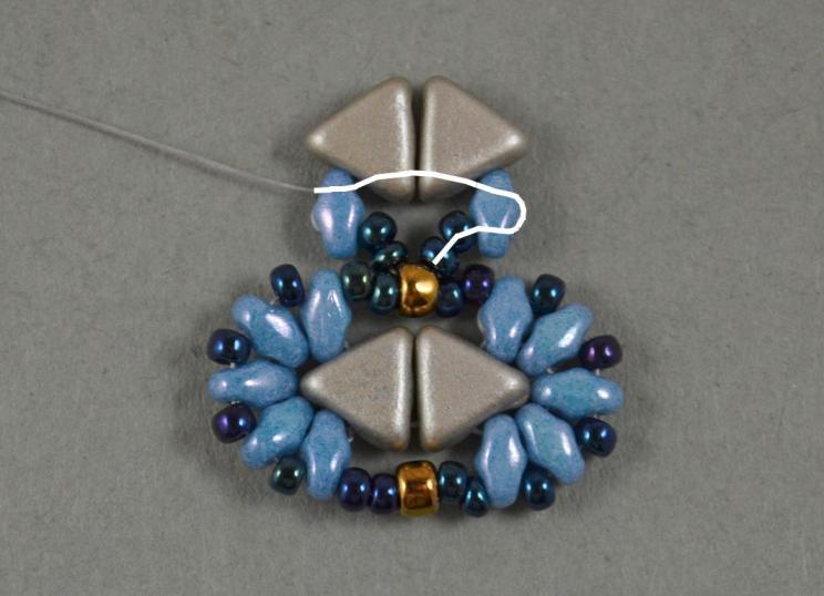 Pick two 11/0 seed beads and take the needle through the 8/0 seed bead.