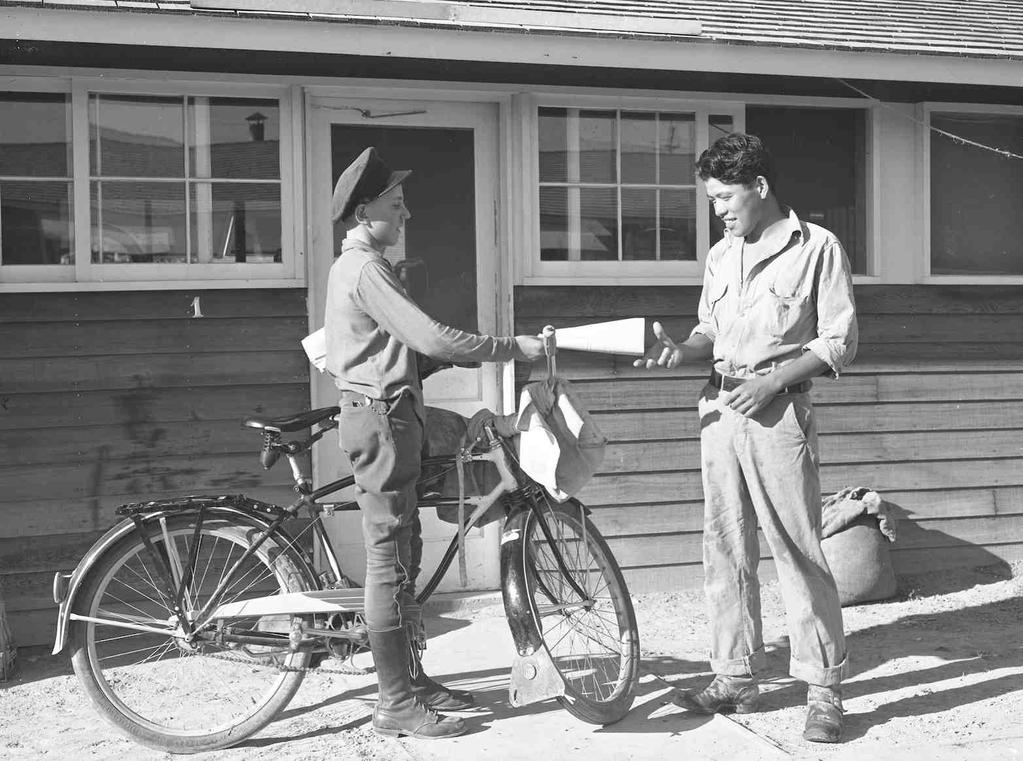 OCHC Lee #010 Delivering newspaper to the camp near Rupert, Idaho. Rupert, Idaho. Former Civilian Conservation Corps camp now under Farm Security Administration management.