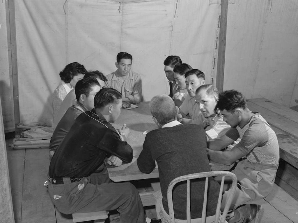 OCHC Lee #015 The camp council, led by Henry Kato, meeting at the Garrison's Corner camp near Nyssa, Oregon. Nyssa, Oregon. Farm Security Administration mobile camp. Camp council meeting.