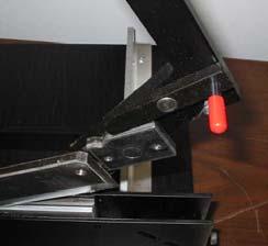 4. Once removed, the handle and knife assembly can be lifted from between the frame. DO NOT LIFT THE BLADE OUT OF THE UNIT UNTIL READING FURTHER.